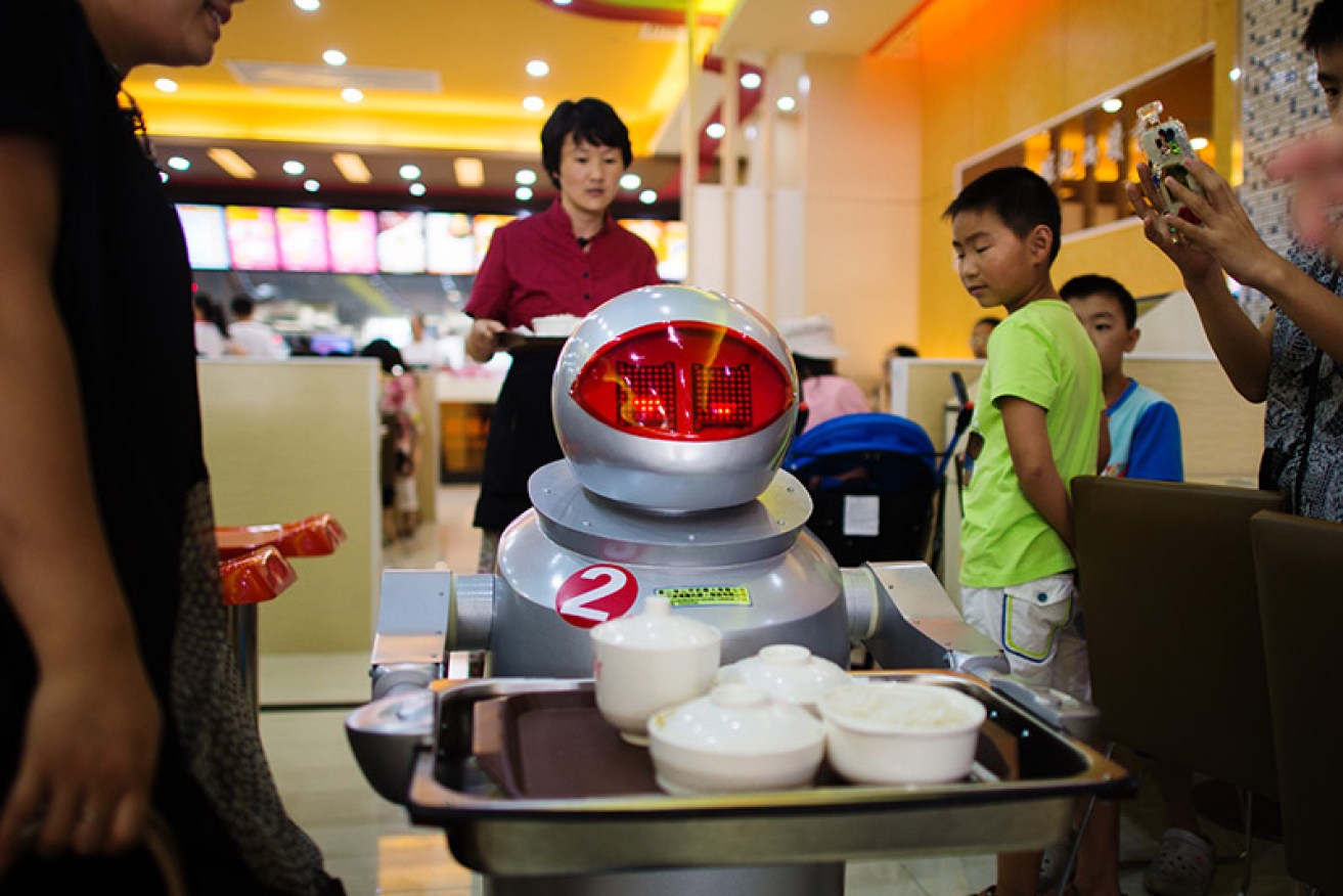 A robot serves customers in a restaurant in Kunshan.