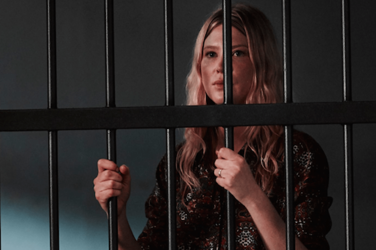 The back-from-the-dead Kate (Emma Booth) behind bars.