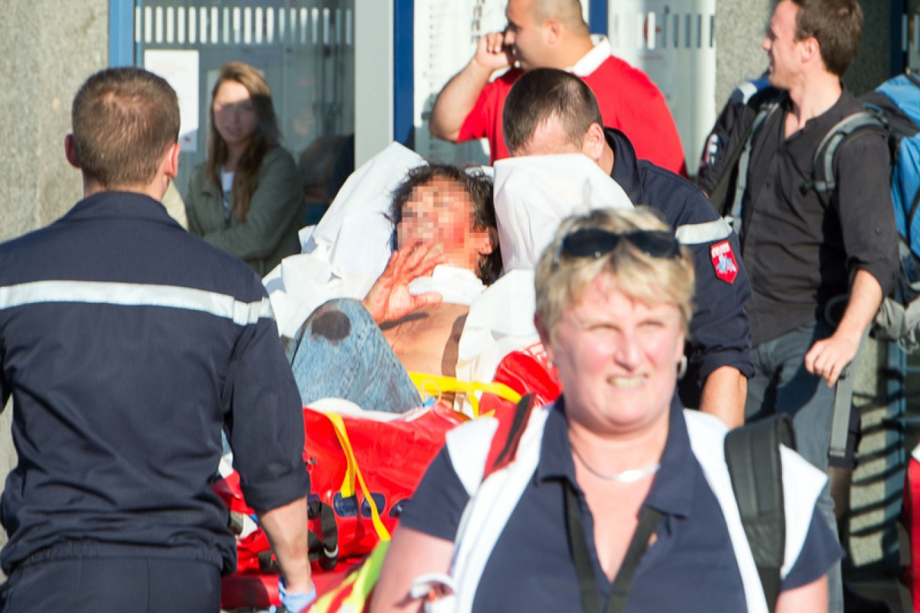 An injured man is carried away on a stretcher. 