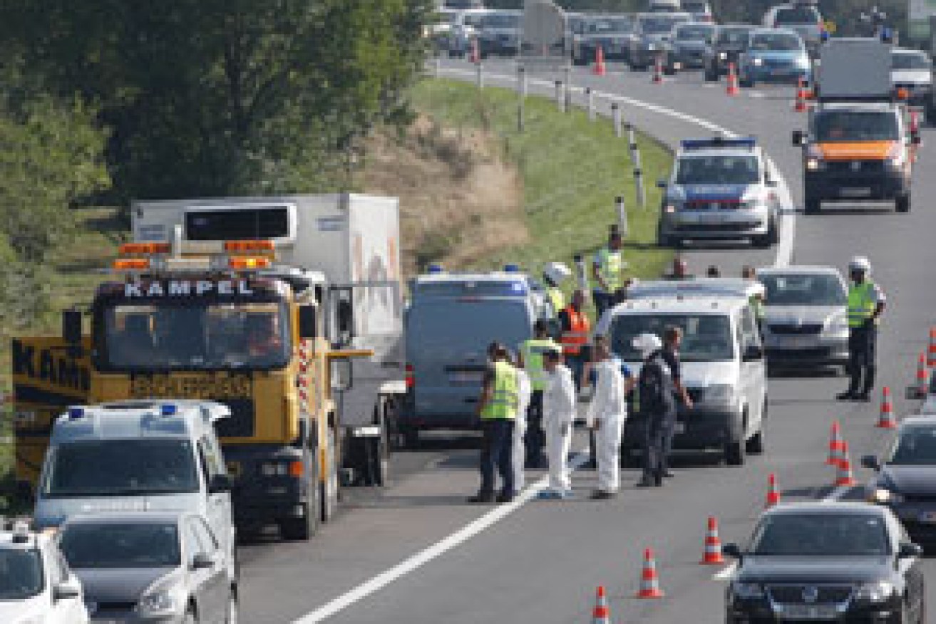Investigators examine the truck, which was found near the border of Hungary and Austria. Photo: AAP