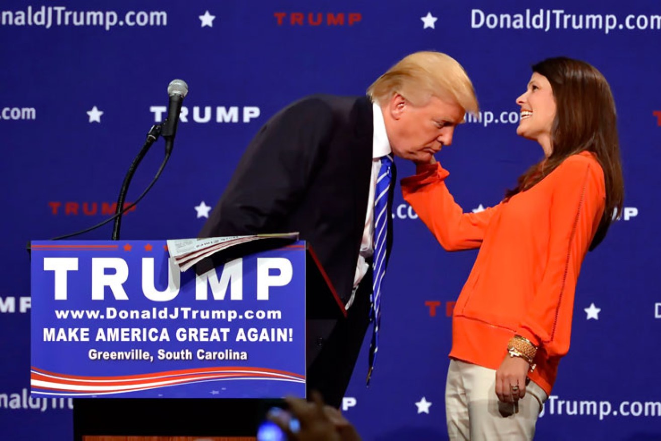 Republican supporter Mary Margaret Bannister tussles Donald Trump's hair. Photo: AAP