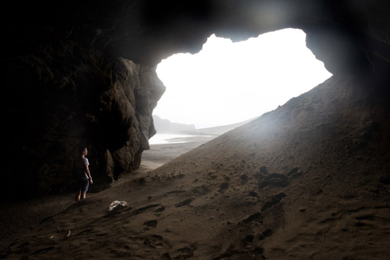 TONGA - JULY 10:  (AUSTRALIA &amp; NEW ZEALAND OUT) Journalist, Peter Munro, stands in a cave on the newest island on Earth, July 10, 2015. It emerged from the waters of the South Pacific in January 2015 when a volcano erupted on the nearby island of Tonga, forcing pulverised magma into the air above the ocean. The magma gradually built up on the ocean floor, penetrating the surface of the water to form the island. (Photo by Edwina Pickles/The Sydney Morning Herald/Fairfax Media via Getty Images)