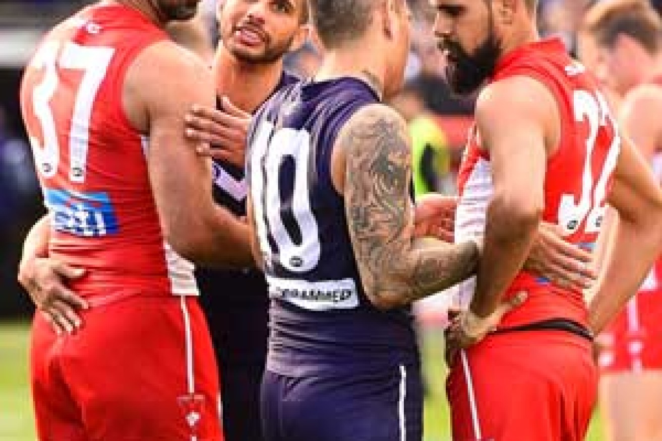 Fremantle's Indigenous players Danyle Pearce and Michael Walters chat to Goodes and Lewis Jetta of the Swans. Photo: Getty