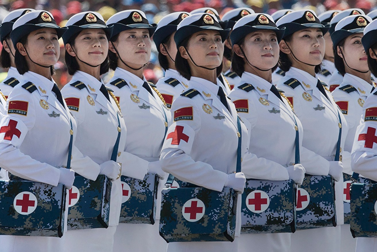 BEIJING, CHINA - SEPTEMBER 03:  Female Chinese soldiers of the medical corps ride in trucks as they pass in front of Tiananmen Square and the Forbidden City during a military parade on September 3, 2015 in Beijing, China. China is marking the 70th anniversary of the end of World War II and its role in defeating Japan with a new national holiday and a military parade in Beijing.  (Photo by Kevin Frayer/Getty Images)
