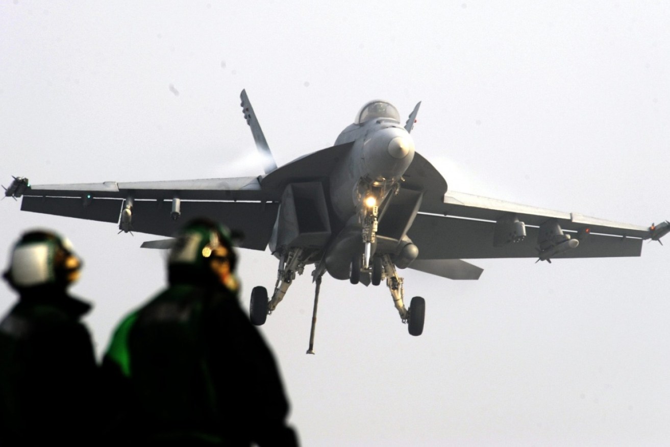 An F-18 and its aerial tanker may have gone done during midair refuelling, sources say.