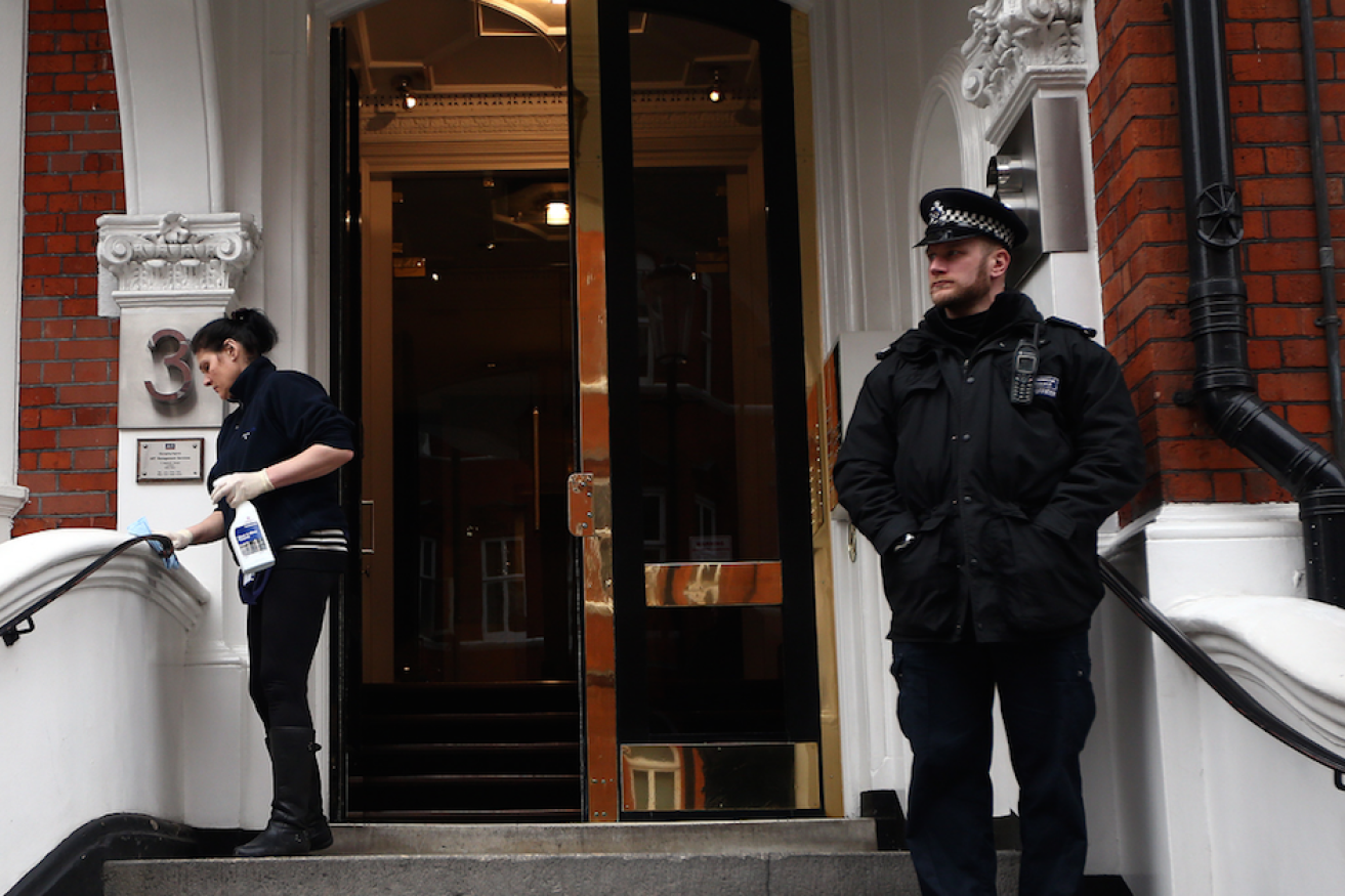 A police officer stands guard at the front of the Ecuadorian embassy in London