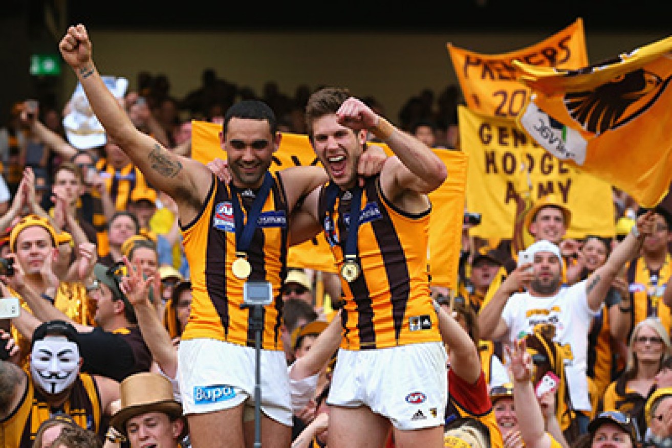 MELBOURNE, AUSTRALIA - OCTOBER 03:  Shaun Burgoyne and Grant Birchall of the Hawks celebrate with the crowd after winning the 2015 AFL Grand Final match between the Hawthorn Hawks and the West Coast Eagles at Melbourne Cricket Ground on October 3, 2015 in Melbourne, Australia.  (Photo by Quinn Rooney/Getty Images)