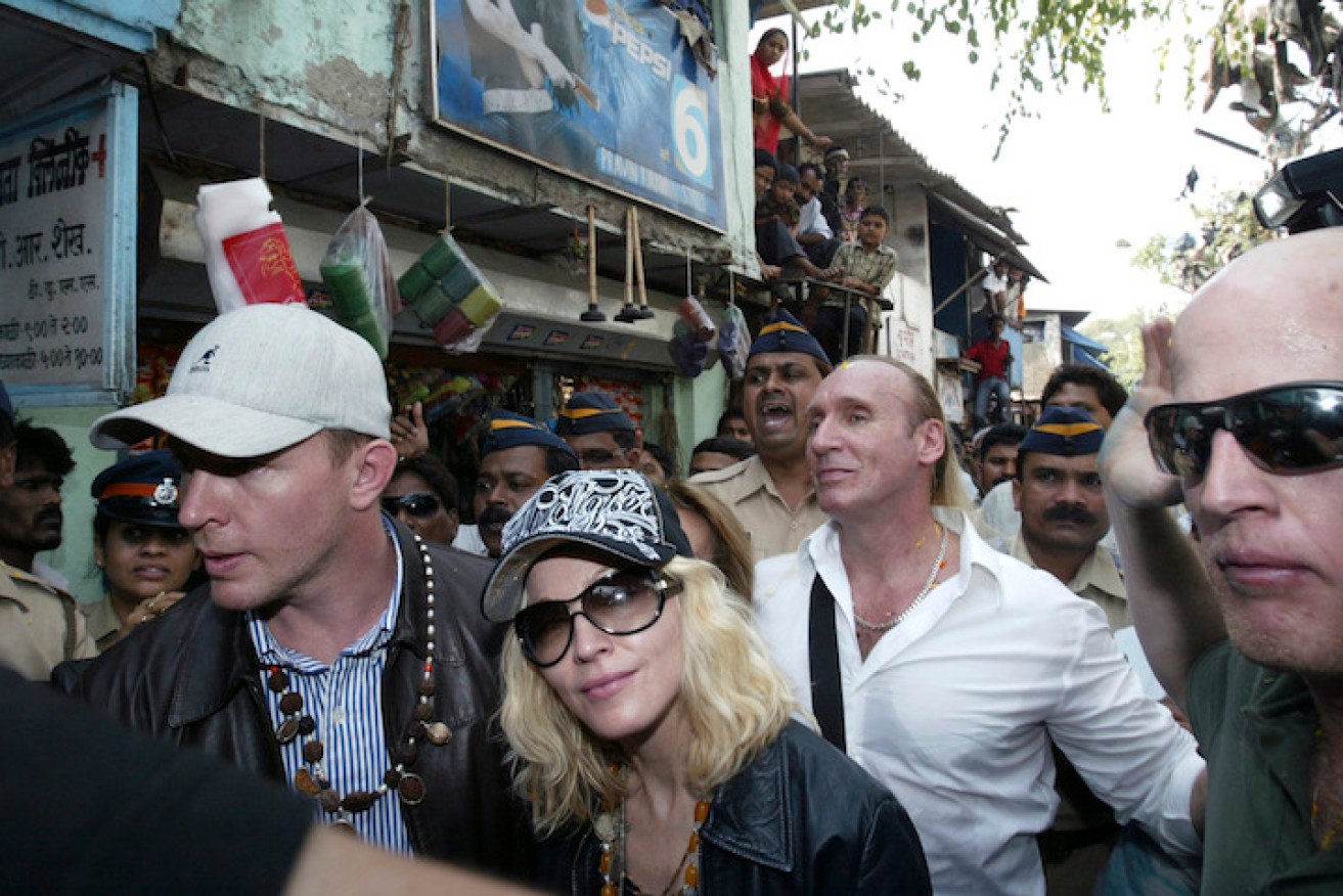 Roberts (right) escorting Madonna and Guy Ritchie through Mumbai in 2008. Photo: AAP