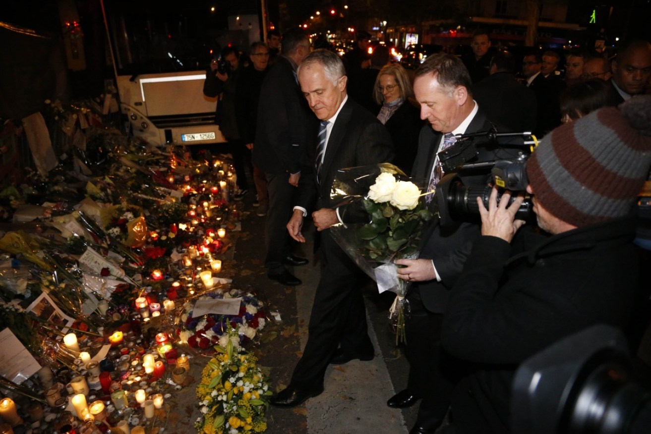 hoto laid flowers at a memorial for the victims of Paris' terrorist attacks in front of the Bataclan.