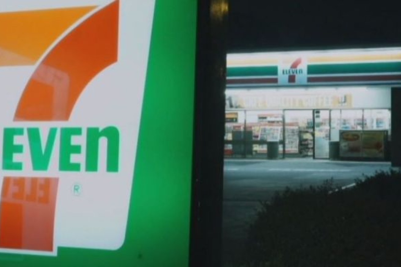 A woman wielding an Two customers were attacked in a 'completely random' attack at a 7-Eleven in Sydney's inner west.