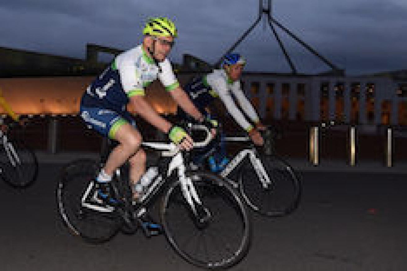 Prime Minister Tony Abbott in action during an early morning bike ride with the Orica GreenEDGE cycling team outside Parliament House in Canberra, Thursday, Nov. 27, 2014. (AAP Image/Lukas Coch) NO ARCHIVING