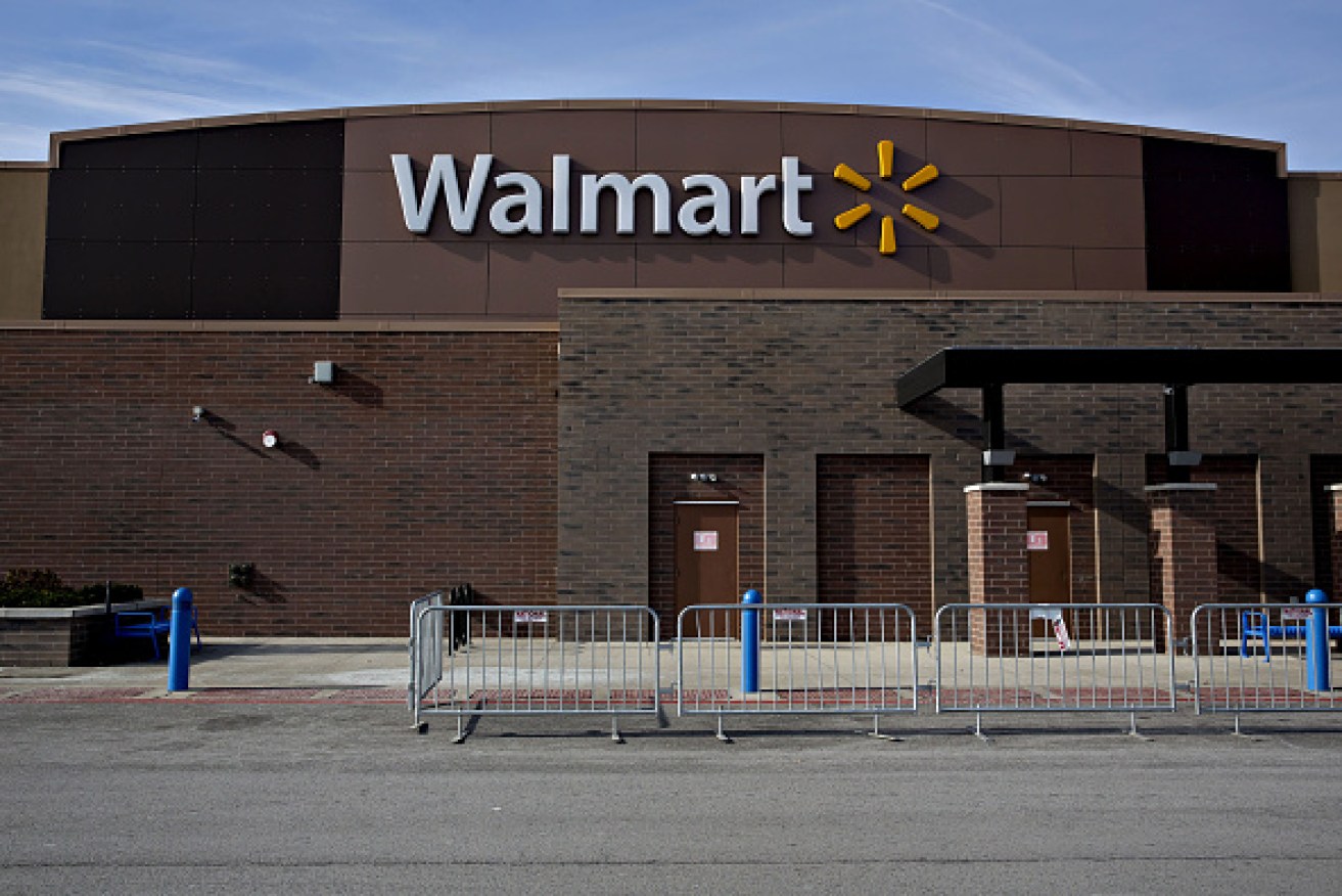 Temporary security fencing sits outside a Wal-Mart Stores Inc. location in Chicago, Illinois, U.S., on Wednesday, Nov. 25, 2015. In 2011, several big U.S. retailers moved their opening times to midnight; in 2012, Wal-Mart crossed the Rubicon and opened its stores at 8 p.m. on Thanksgiving Day. But after last year's Thanksgiving weekend retail sales fell 11 percent from the year before while overall holiday sales rose, some retailers have been reconsidering. Photographer: Daniel Acker/Bloomberg via Getty Images