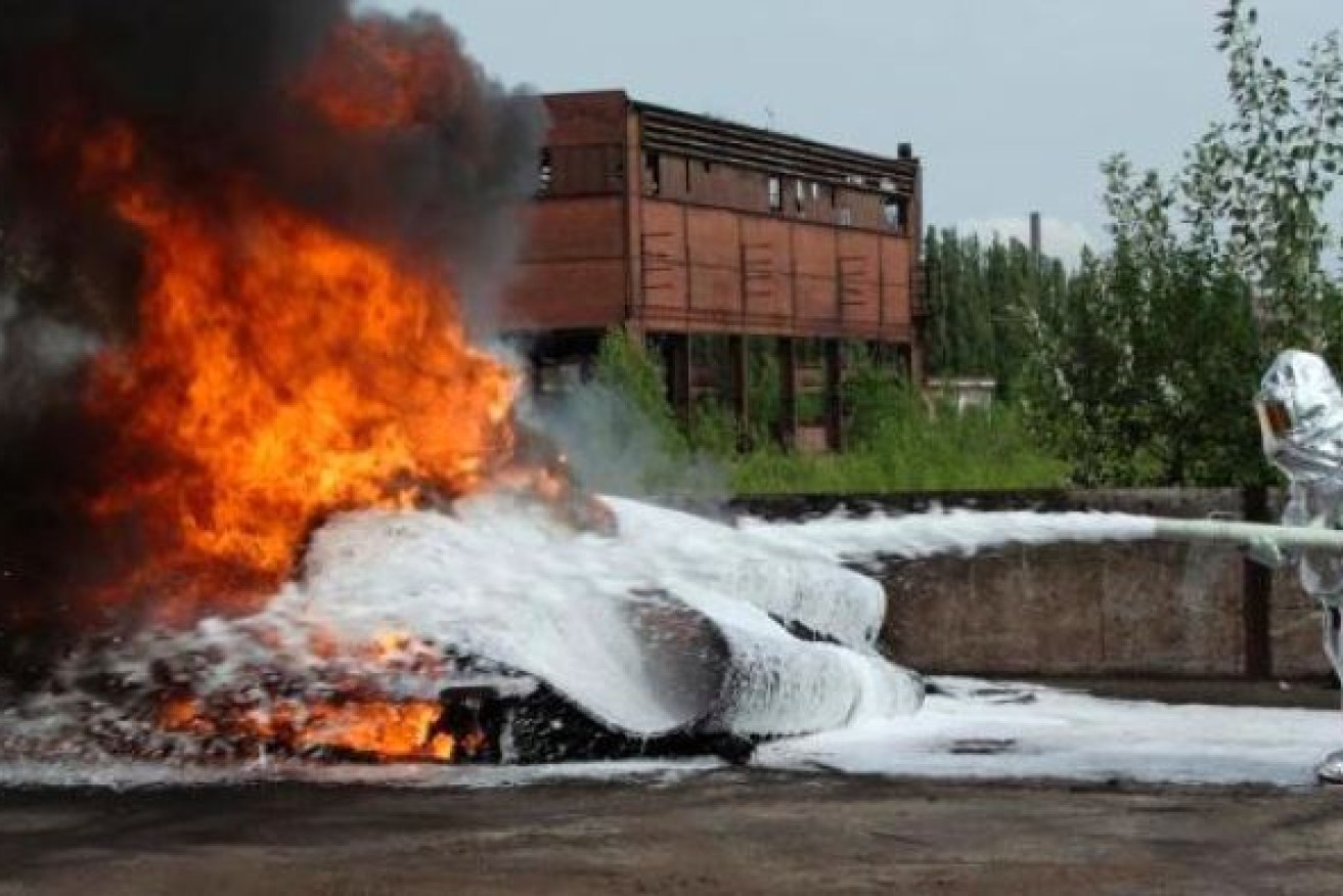 Firefighting foam, shown here in a controlled test, has prompted warnings against eating fish from certain Brisbane waterways.