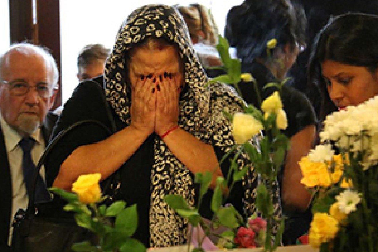 A woman mourns at the service at Urban India. Photo: ABC/Isabel Dayman