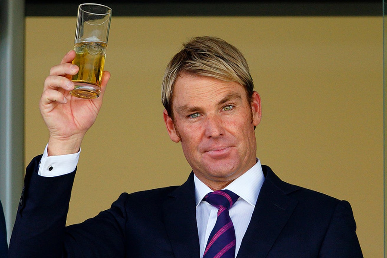 Put a cap on it: Shane Warne is doing his bit for for fire relief. Photo: AAP