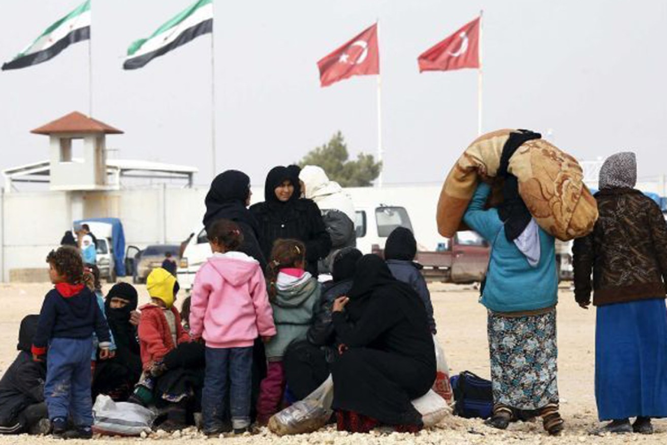 Internally displaced Syrians wait near the Bab al-Salam crossing.

Reuters: Osman Orsal