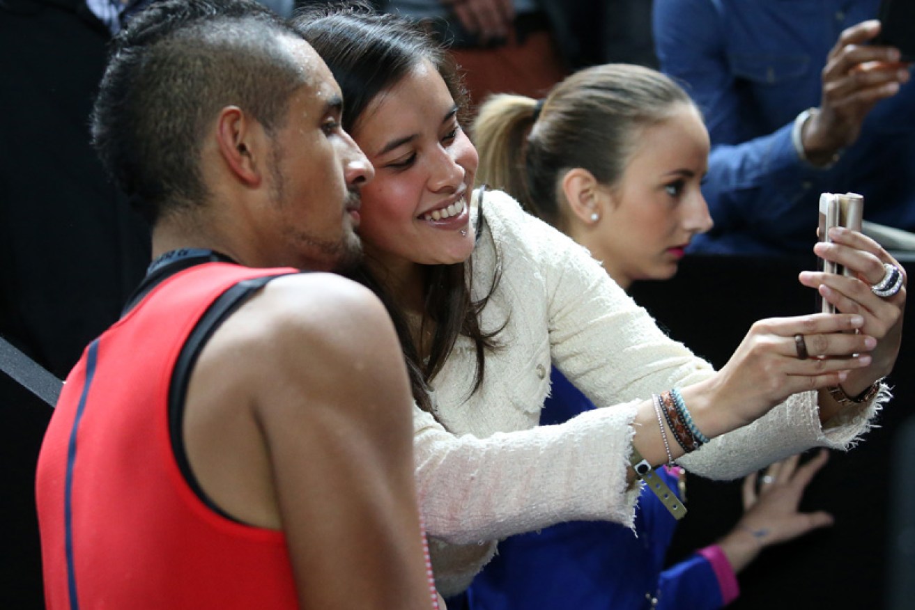 Kyrgios poses for a selfie after the win. Photo: Getty