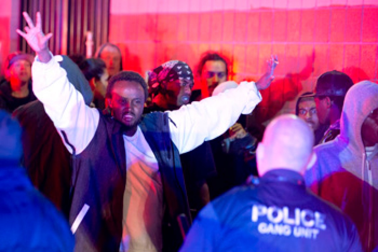 Police advance on an angry crowd following the shooting. Photo: AAP