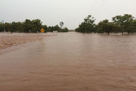 Dry outback Queensland towns flooded, roads cut