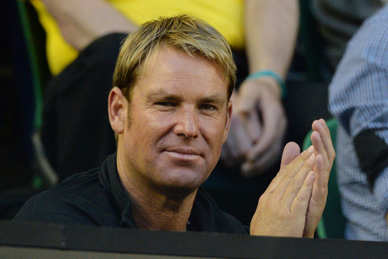 Shane Warne faces a $300 fine for not wearing his seatbelt in Hobart.