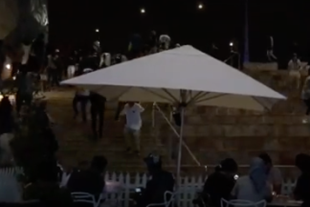 Youths scramble down steps at Federation Square, presumably from police. Photo: YouTube.