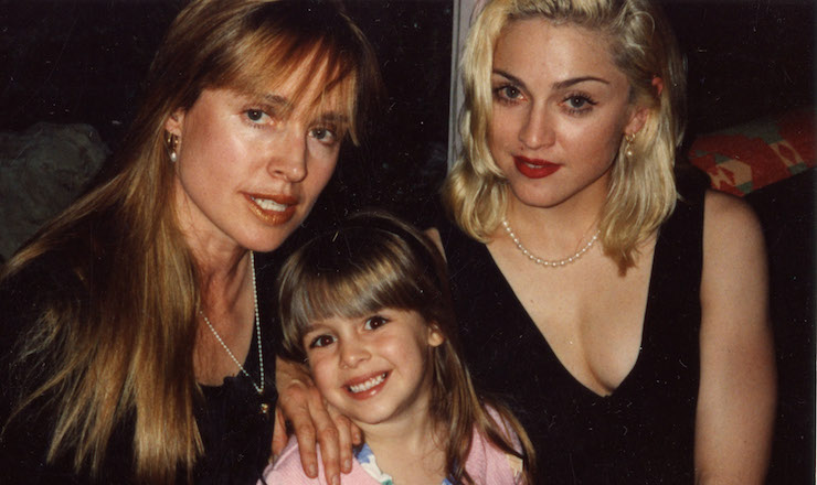 Hobbs (left) with her daughter Lola (centre), who hit it off with Madonna (right).