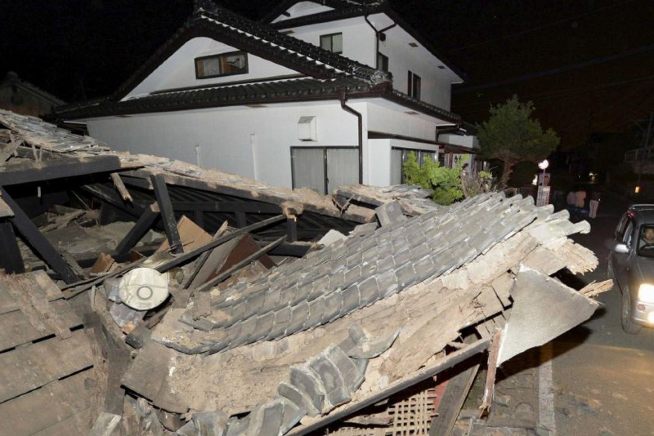 A collapsed house is seen after an earthquake in Kumamoto. ABC