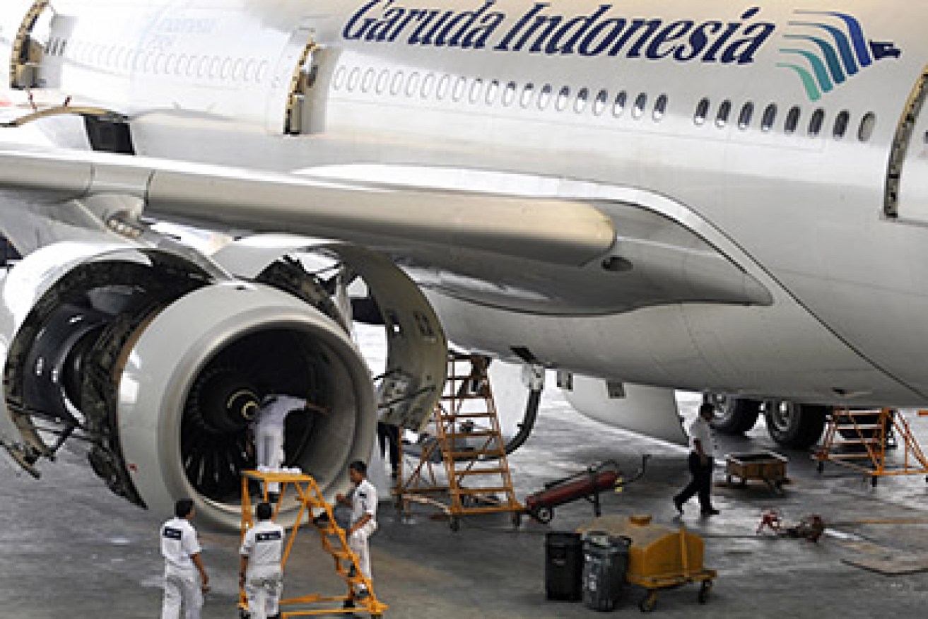 Aircraft technicians check the Rolls Royce engine of Garuda Indonesia's Airbus A330-300 aircraft at the company hangar in Jakarta airport on July 15, 2009. Indonesia, hoping for an upturn in European tourism, welcomed the EU's decision to remove four Indonesian airlines including crash-blighted Garuda Airlines from its aviation blacklist. Once reeling from a spate of deadly accidents, flag-carrier Garuda said it planned to resume flights to Europe as early as next year, and is also eyeing the lucrative US market. AFP PHOTO/ROMEO GACAD (Photo credit should read ROMEO GACAD/AFP/Getty Images)