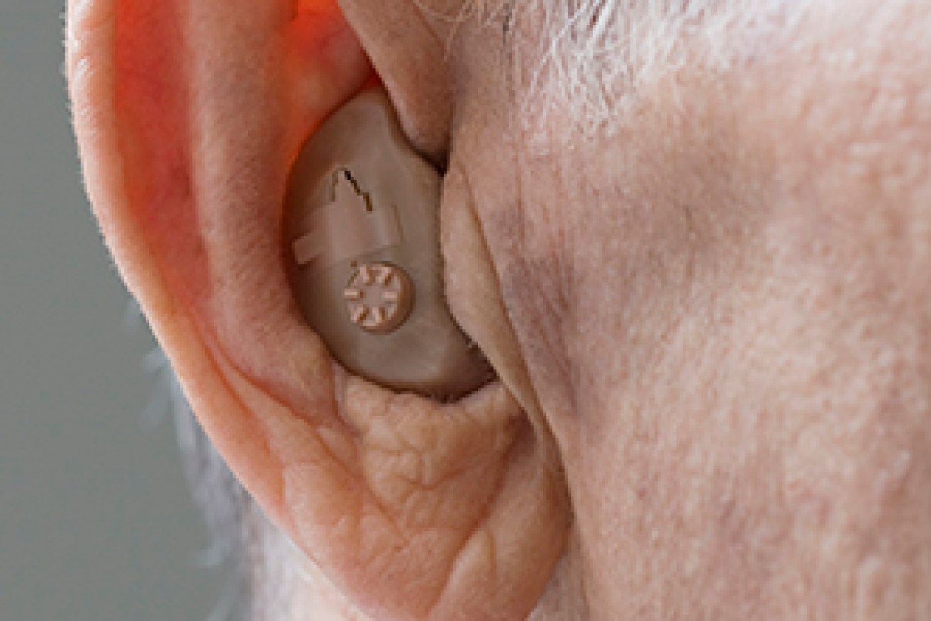 Close up of senior Hispanic man’s hearing aid