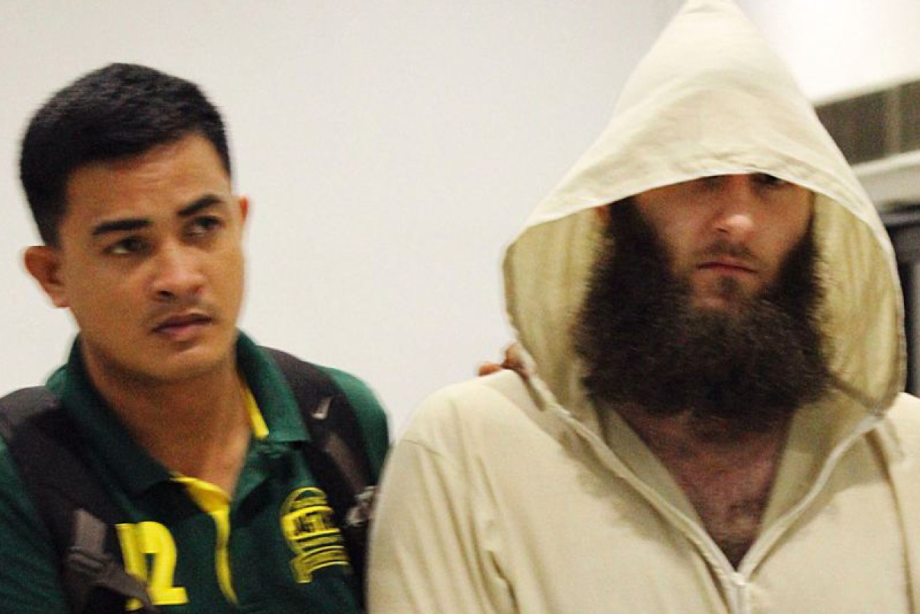 Musa Cerantonio is escorted by police after his arrest in the Philippines in 2014.
