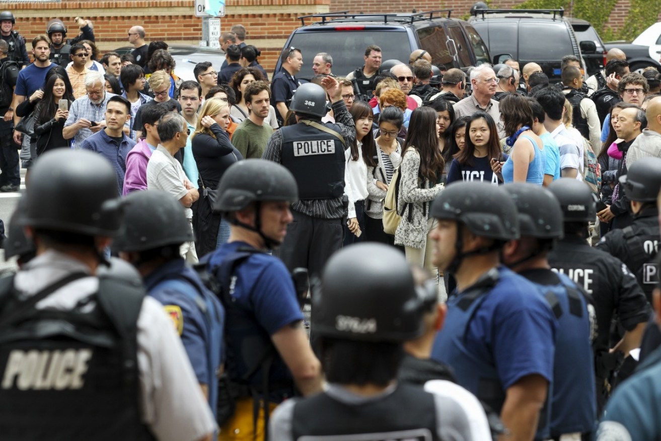 UCLA students and faculty members are escorted by police. Photo: AAP.