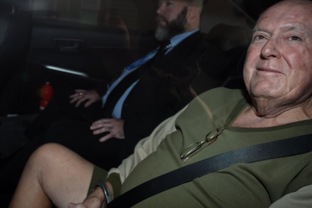 John Chardon is brought into the police watch-house Brisbane. Photo: AAP.
