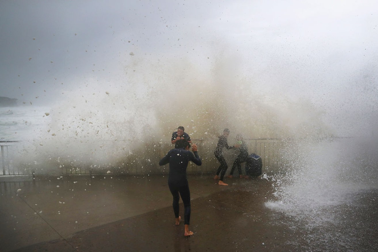 Children get soaked at Sydney's Bronte Beach – wild storms are predicted to increase with climate change.