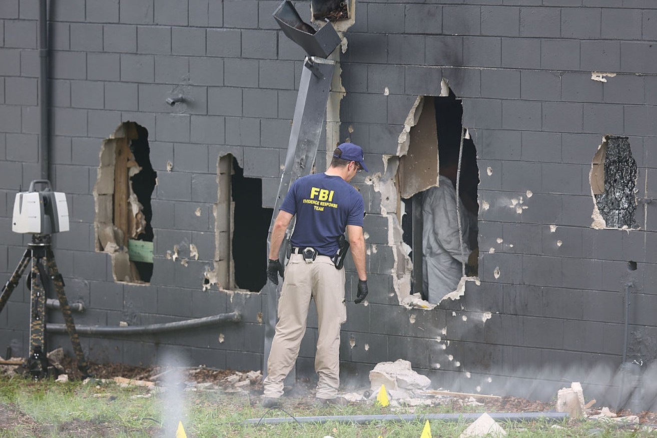 Holes in the wall of the nightclub through which police tried to gain access. Photo: Getty.