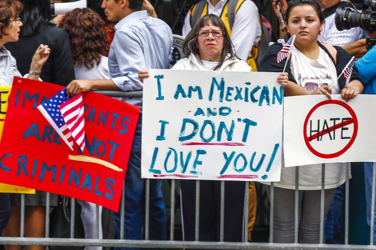 Members of the Mexican community protest against Donald Trump in Chicago. Photo: AAP.