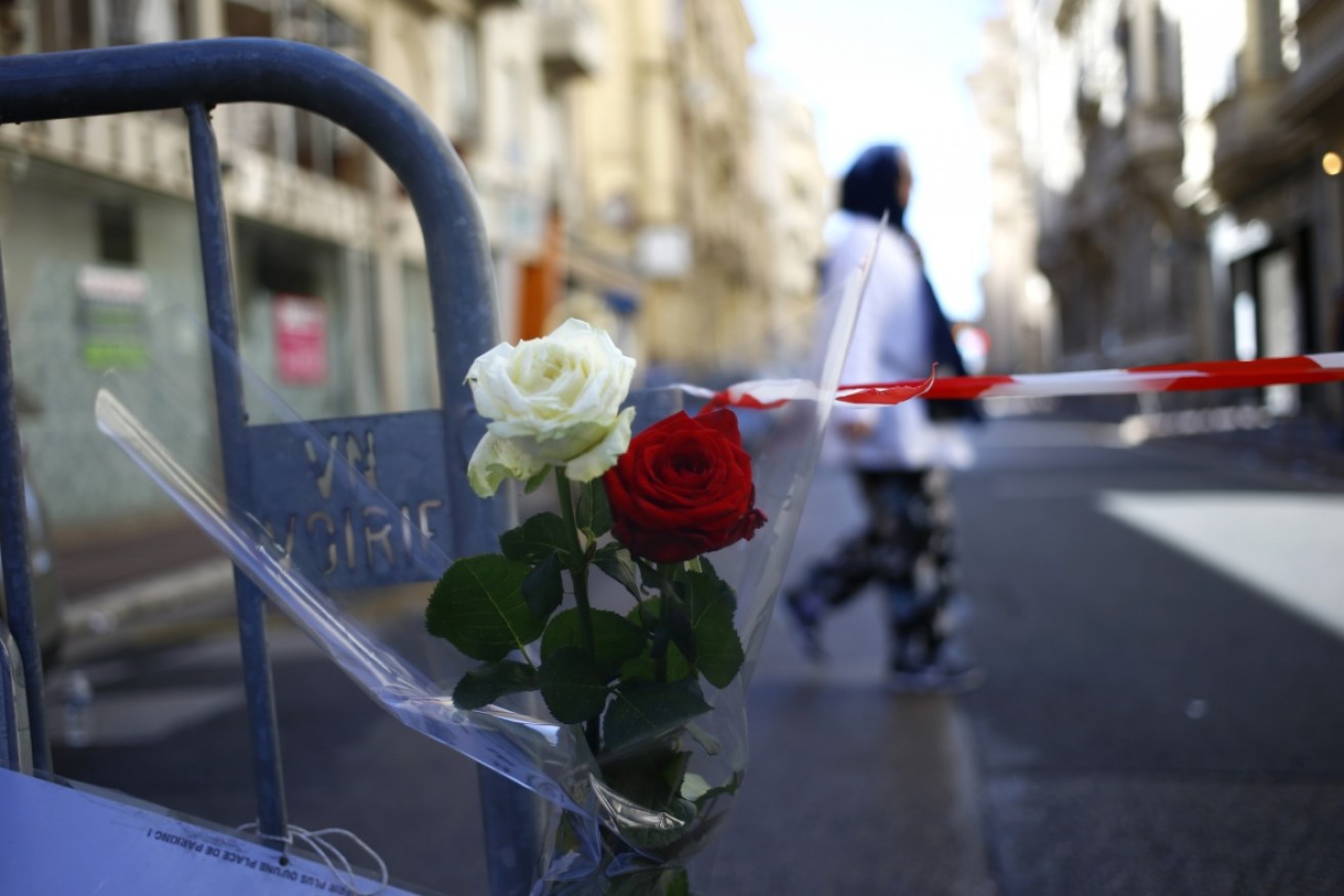 Roses at a barrier near the scene after the truck attack. Photo: AAP