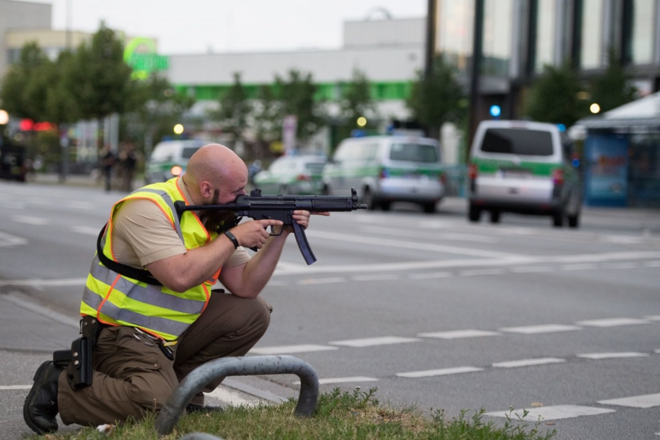 A police officer searching for the gunman following the mall massacre. 