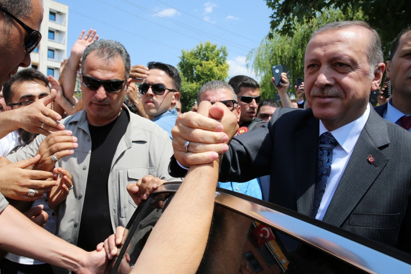 President Erdogan greets supporters outside the Osmanli mosque in Ankara.