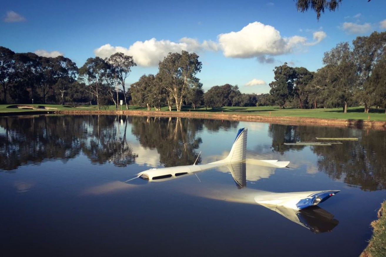 The plane landed in a man-made lake on the 10th hole.