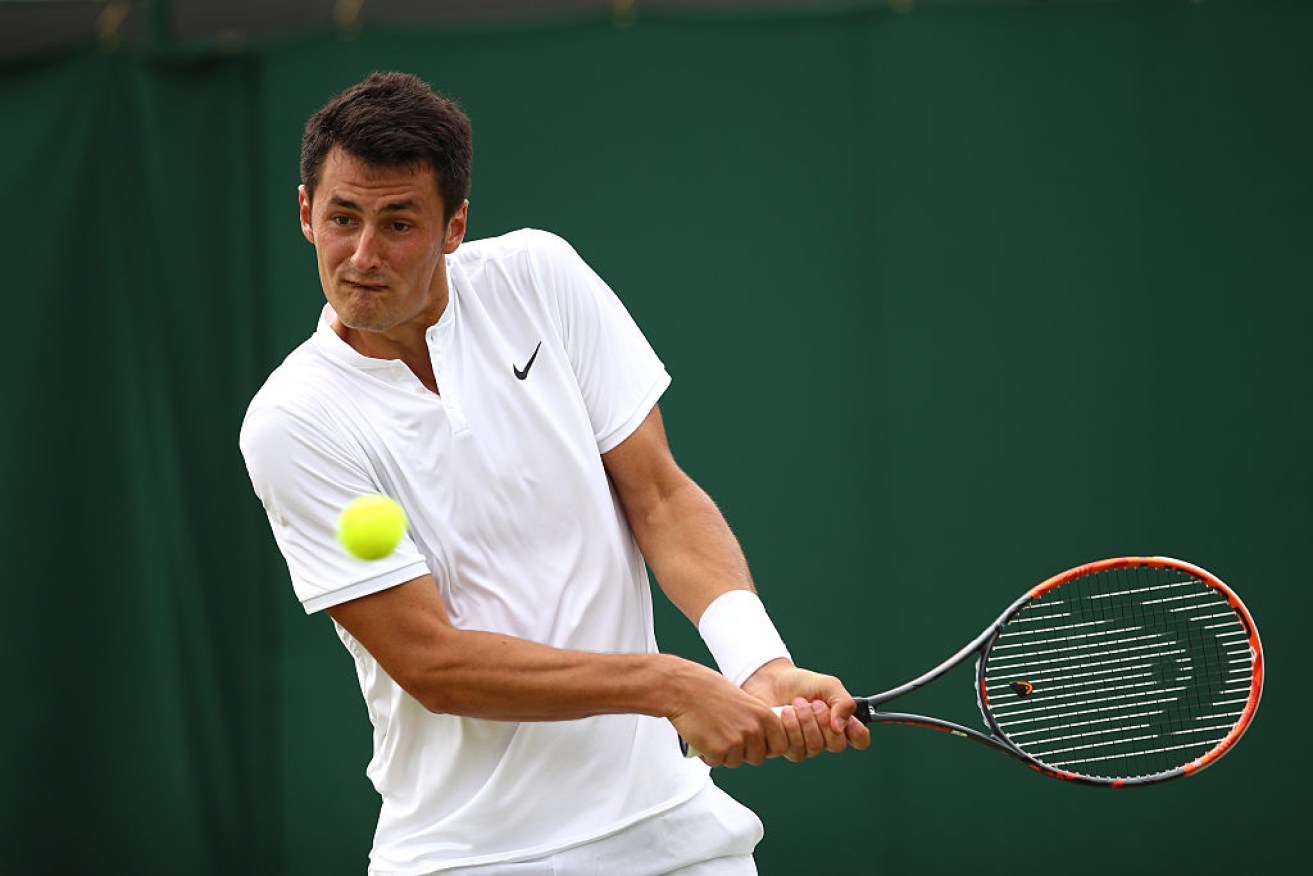 LONDON, ENGLAND - JUNE 30:  Bernard Tomic of Australia plays a backhand during the Men's Singles second round match against Radu Albot of Moldova on day four of the Wimbledon Lawn Tennis Championships at the All England Lawn Tennis and Croquet Club on June 30, 2016 in London, England.  (Photo by Clive Brunskill/Getty Images)