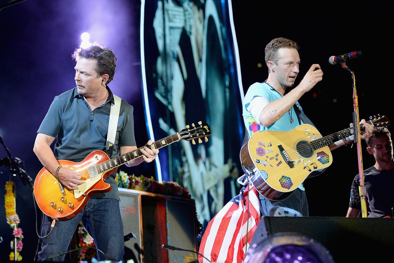 Michael J. Fox (L) performs onstage with  Chris Martin of Coldplay.