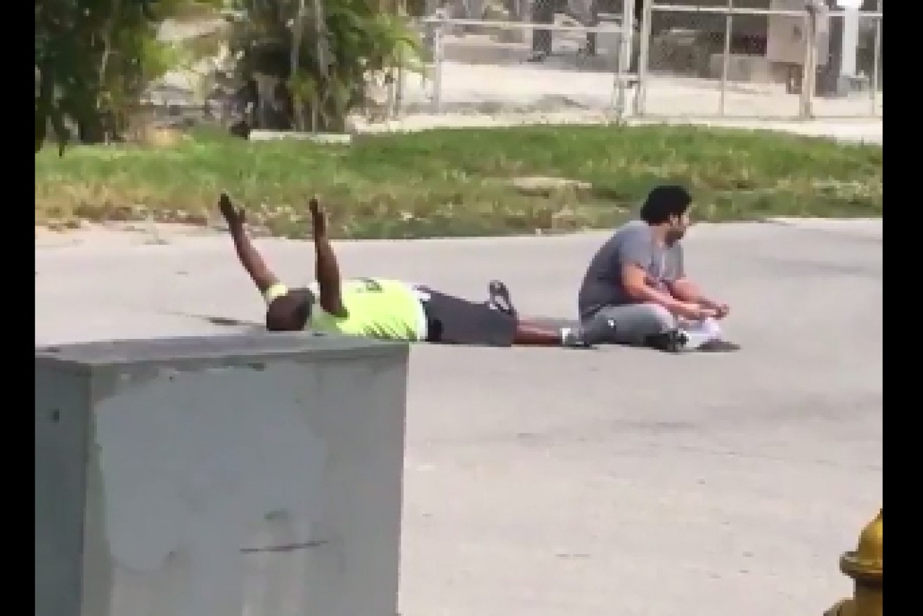 A grab of Charles Kinsey with his hands in the air. 