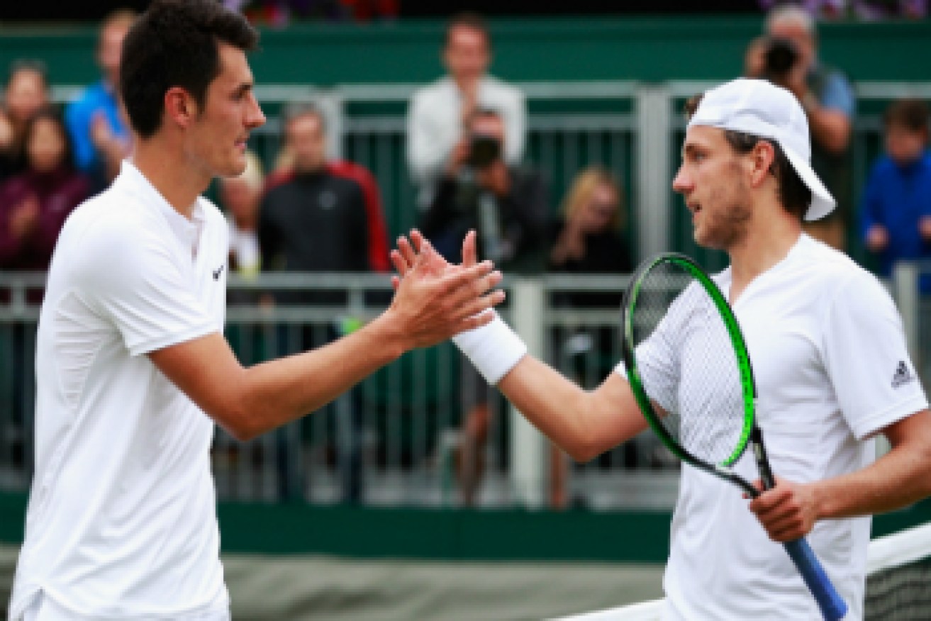 Tomic shakes Pouille's hand. Photo: Getty