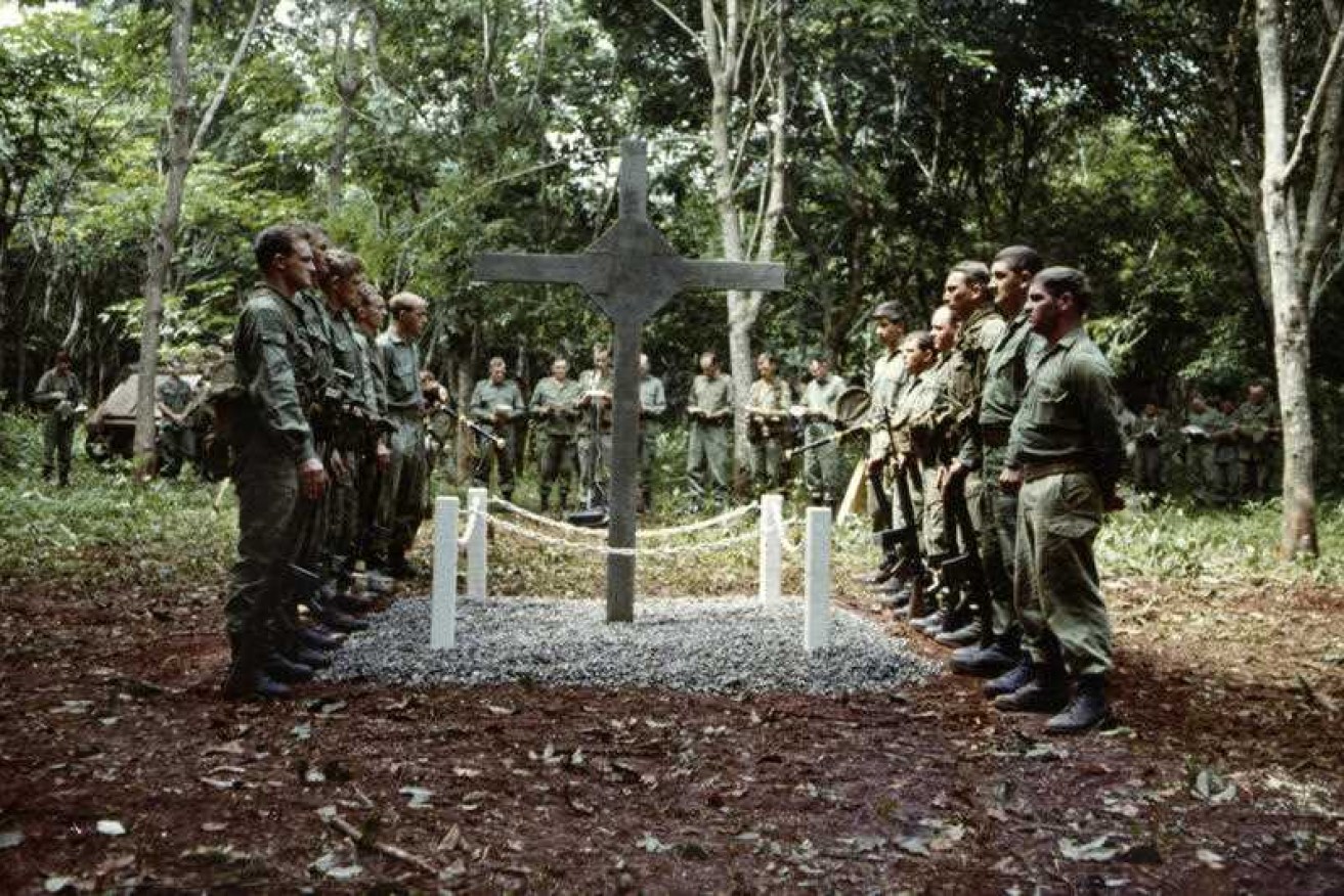 Australian soldiers at the monument known as the Long Tan Cross.