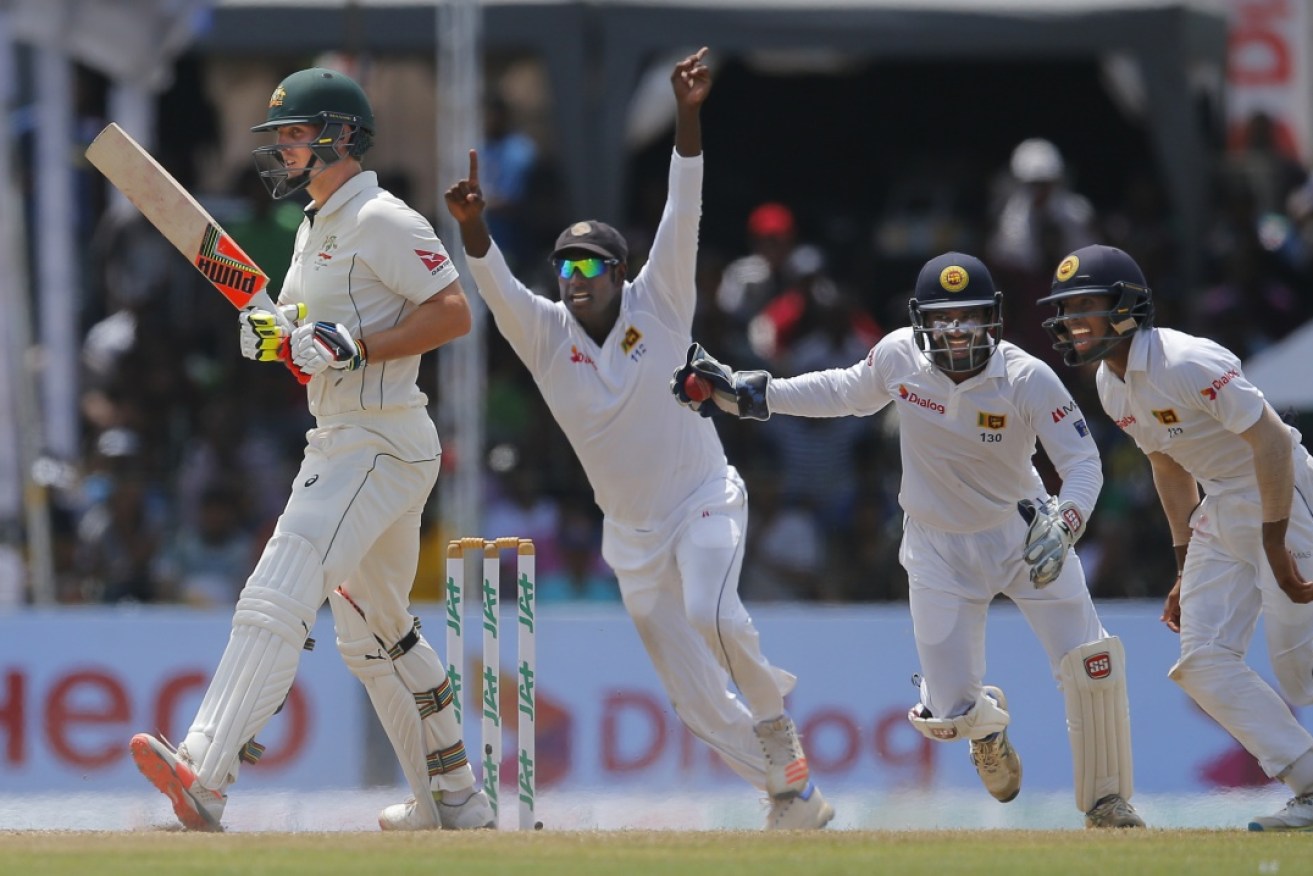 The Sri Lankans celebrate the wicket of Mitchell Marsh on the final day.