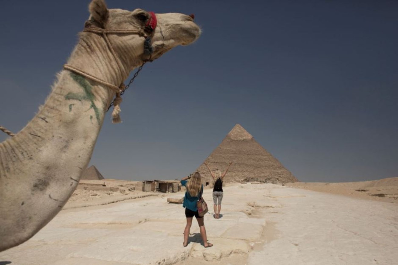 A few tourists have the Great Pyramid of Giza to themselves.