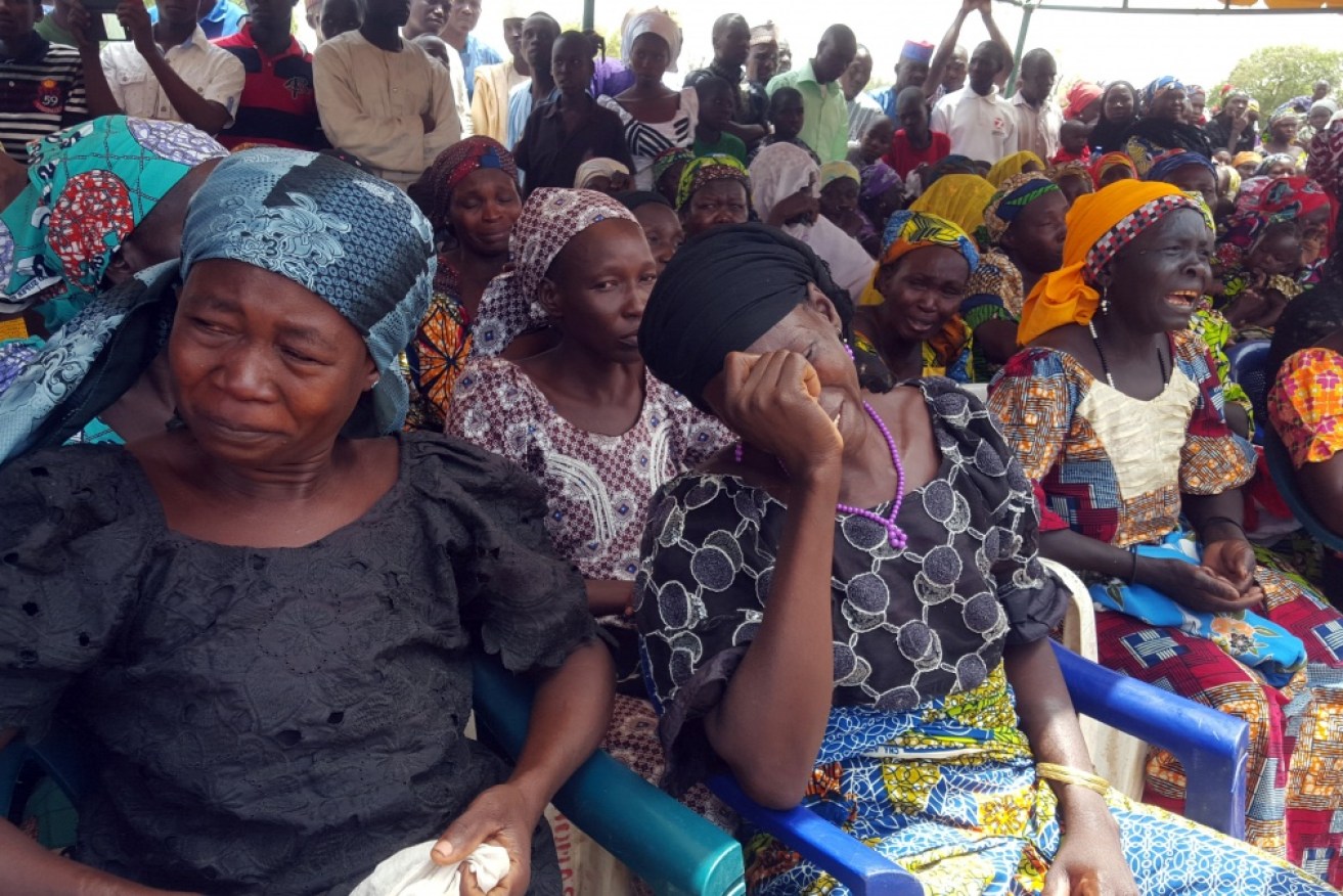 Parents and relatives of the missing Chibokschoolgirls weep during a vigil at the school in April. 