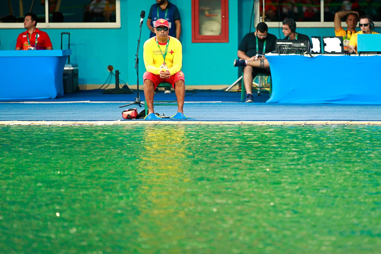 A lifeguard sits by the edge of the diving pool during the Women's Diving.