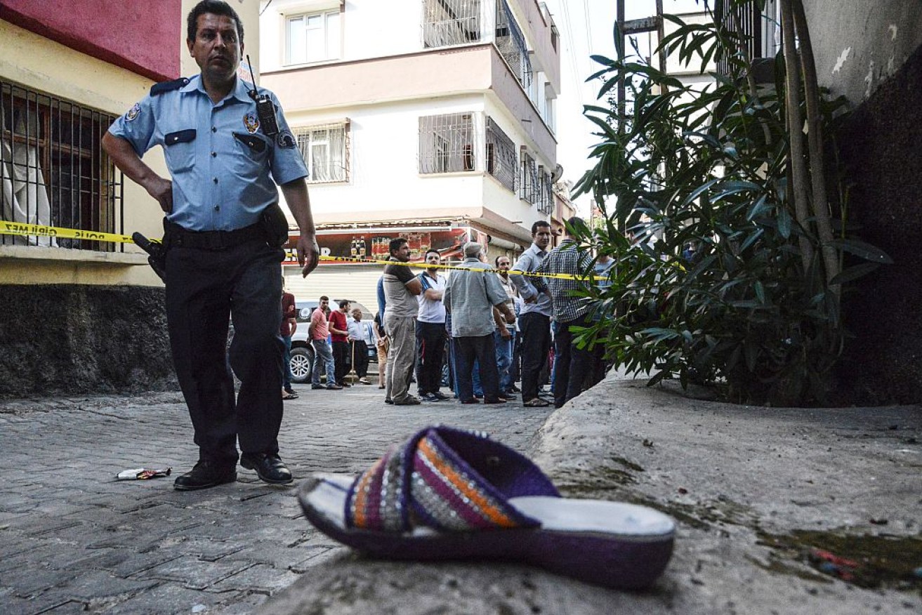 A Turkish policeman stands next to a shoe near the explosion scene.