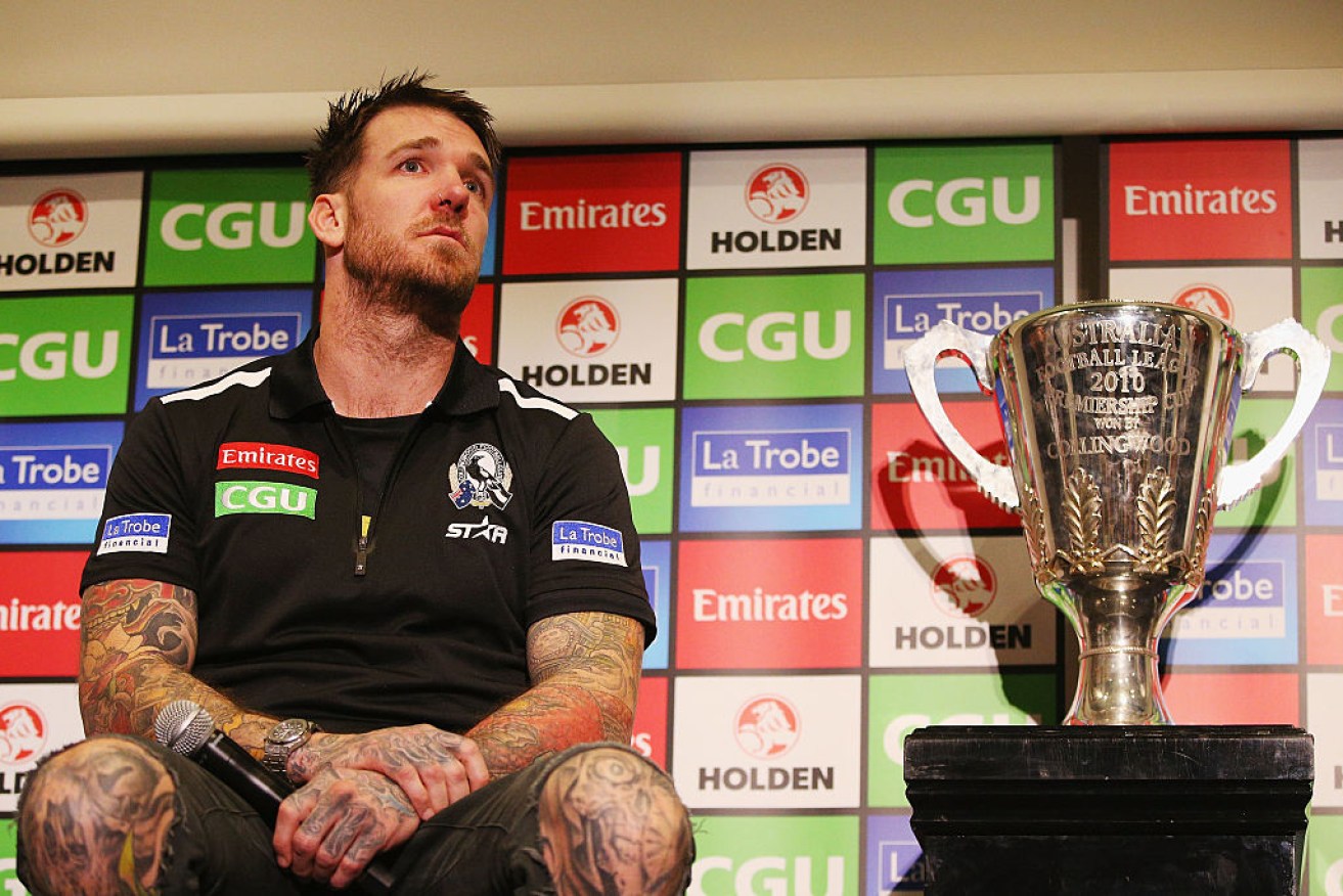 Retiring Dane Swan poses with the 2010 premiership cup.